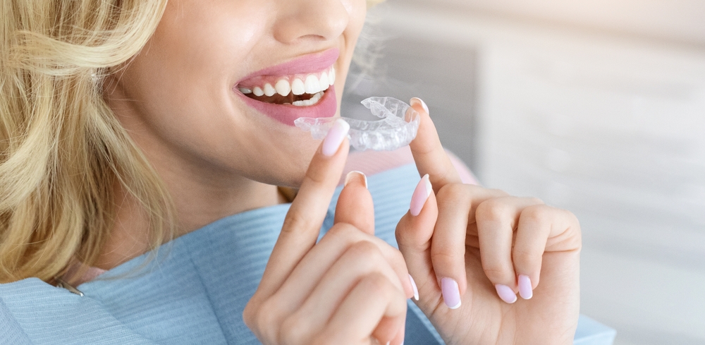 Blonde woman smiling with Invisalign